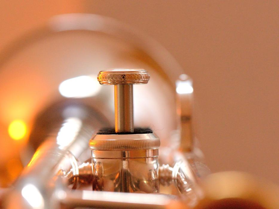 Closeup of the beautiful, shiny silver trumpet with the valve