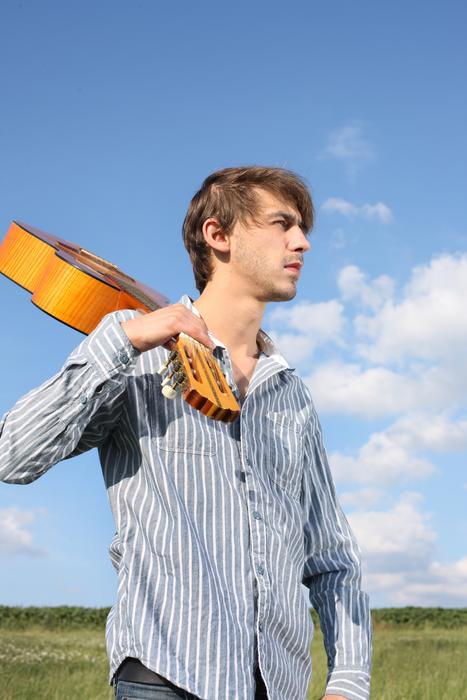 guy with a guitar on the street