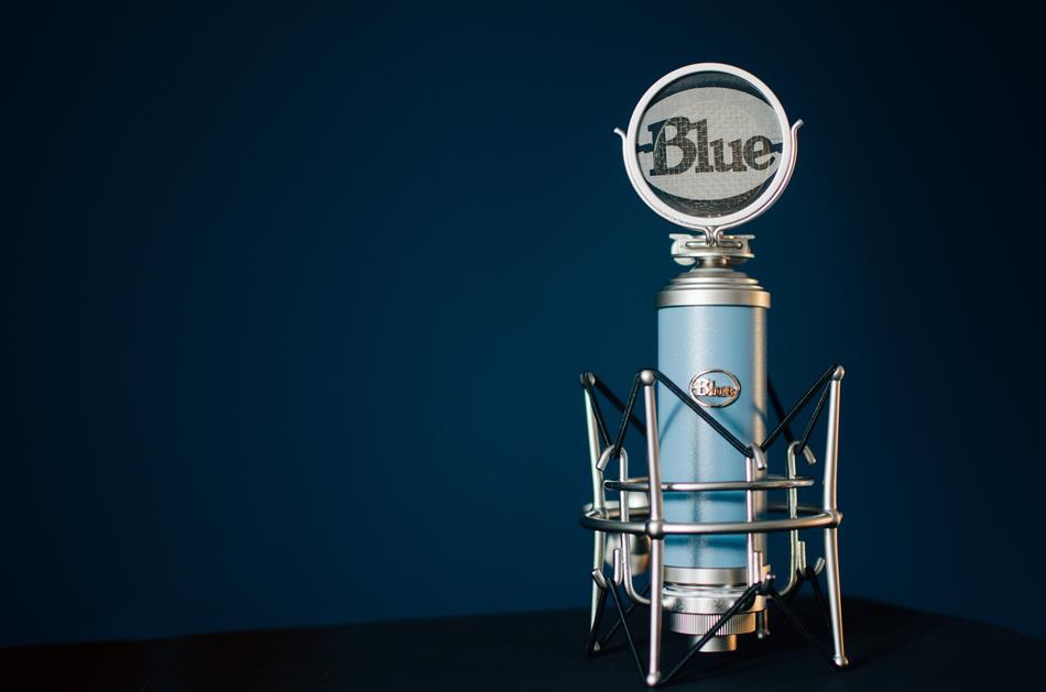 microphone with blue logo on dark background