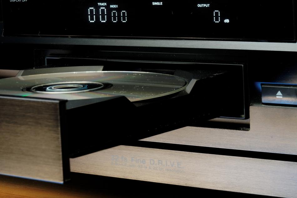 Close-up of the beautiful, shiny cd in the cd player and digits on the display