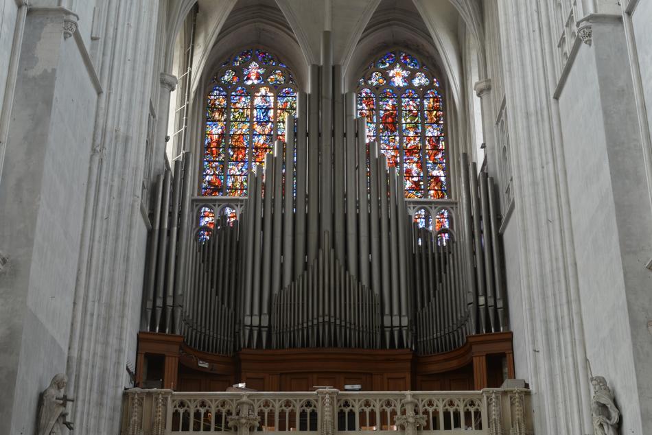 Organ in front of stained glass window in Church