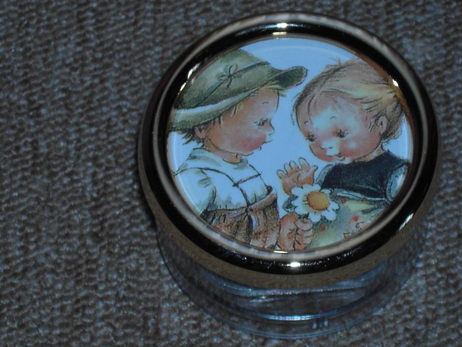 Beautiful and colorful clock with children and white and yellow flower