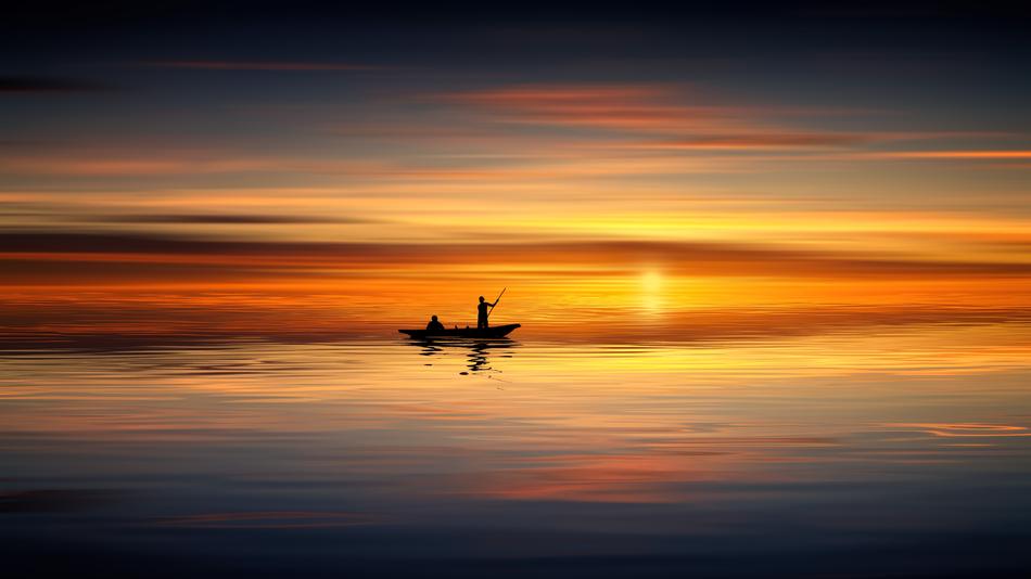 people in Boat on calm sea at sunset