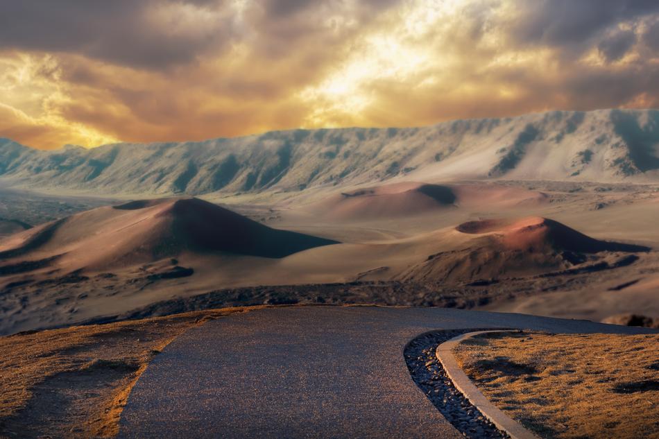 Beautiful highway going to volcanic mountains at beautiful and colorful sunset
