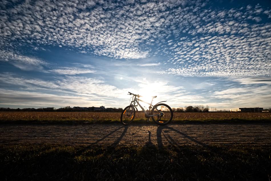 parked bicycle at scenic evening sky