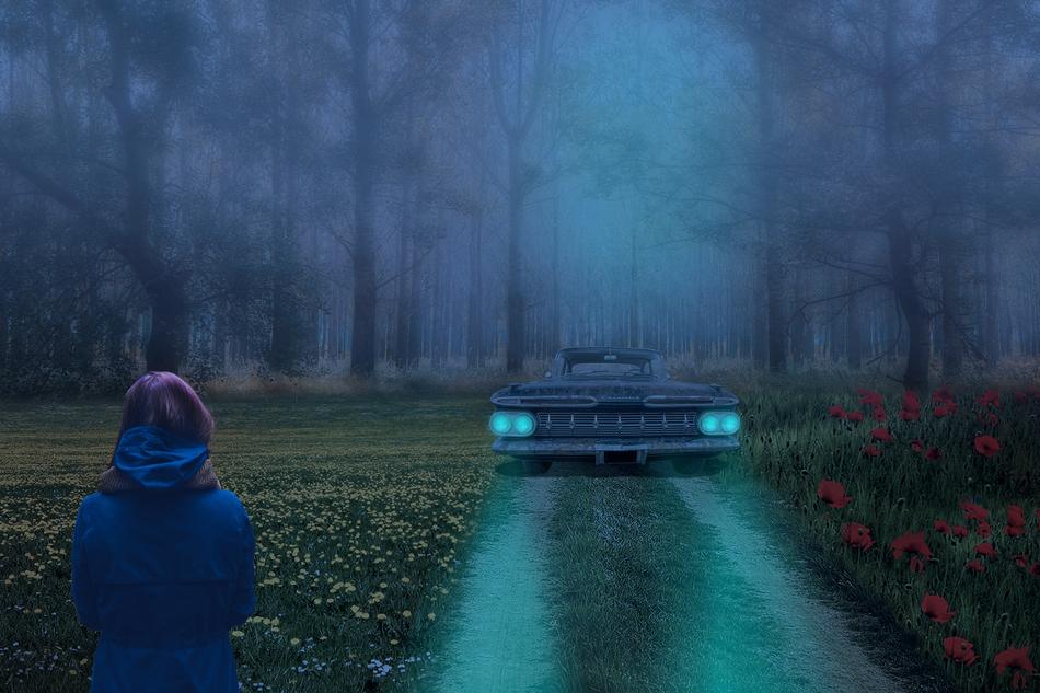car with green headlights in the mystical forest