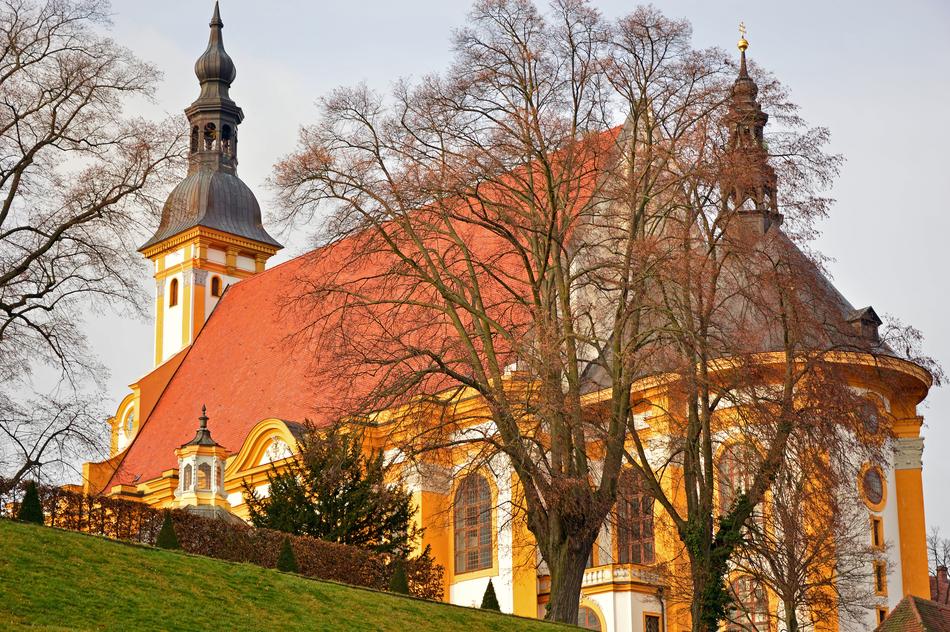 Beautiful and colorful monastery with steeples, among the trees in Neuzelle, Germany