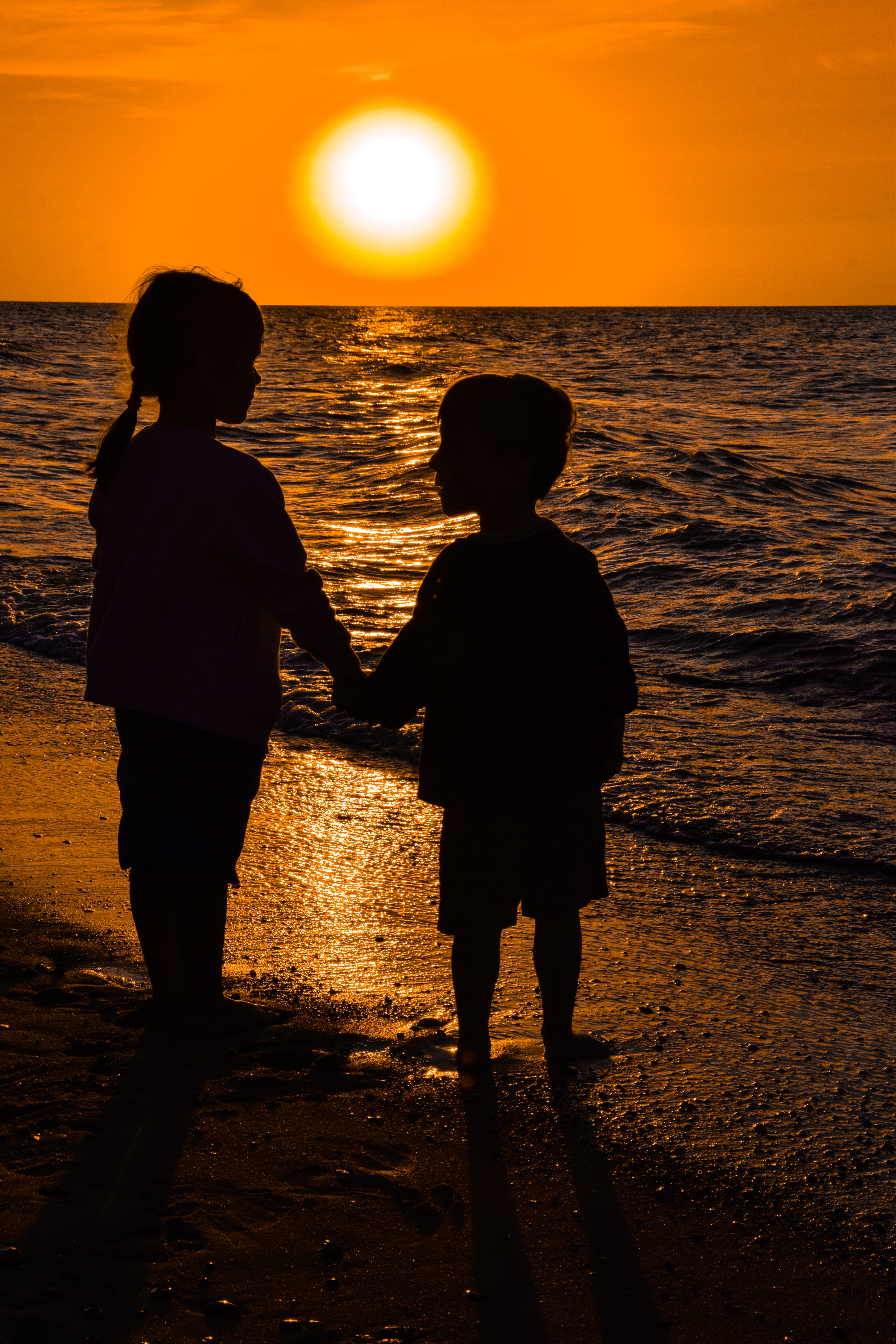 Child Girl And Boy Holding Hands In Front Of Sea At Sunset Free Image Download