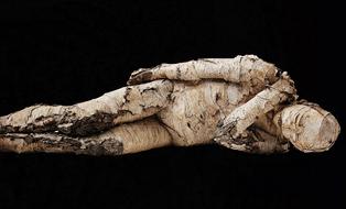 resting wood statue of a man
