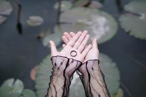 ring in hand over the pond