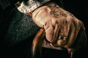 hand of an elderly man on a cane close-up