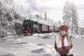 Girl on the winter landscape with the train among the plants