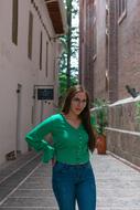 Young long haired Woman posing in alley