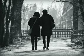 people on a walk in the park in black and white