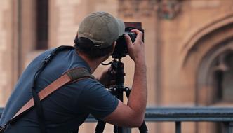 the photographer takes a picture of the famous building