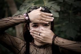 photo model covers her face with her hands