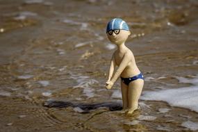 ceramic figurine of a boy in the water