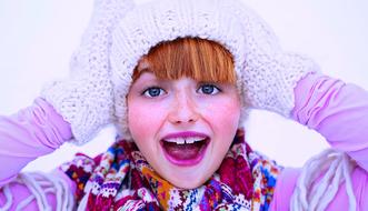 Portrait of cheerful girl in winter clothes