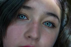 beautiful woman with expressive green eyes close up