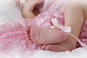 photo of baby feet and pink bow close-up