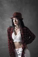 portrait of a girl in a hat and a plaid shirt