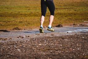 photo of runner's legs on a pathway