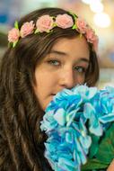 portrait of a beautiful girl with a bouquet of blue flowers