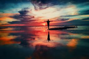photo of a free man against the background of a colorful sunset