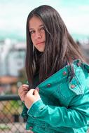 photo of a girl in a turquoise jacket