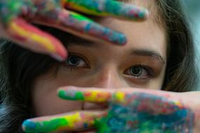 beautiful girl with hands in paint close-up