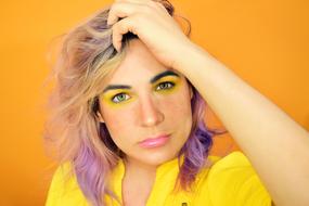 portrait of young caucasian woman with colorful makeup