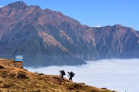 two tourists climb a mountain in Nepal