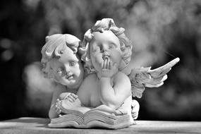 angels, two winged children with book, sculpture