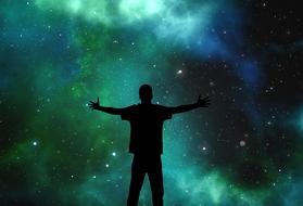 Silhouette of the person at colorful Universe background