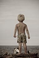little boy by the ocean