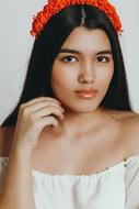 brunette model with a red wreath on her head