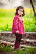 little girl on the farm on a blurred background