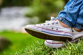 white sneakers and green grass