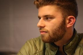 young man in profile on a blurred background