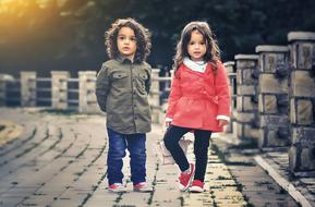 photo of brother and sister on a stone bridge