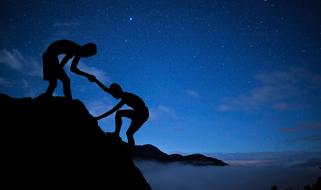 silhouette of people on the top of the mountain