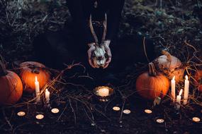 candles among pumpkins as decoration for halloween