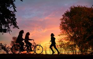 Cyclists and Runner silhouettes on the colorful background
