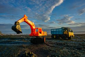 heavy equipment on the beach as a toys