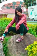 portrait of a girl sitting on a stone