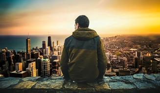 Man Sitting and looking at City