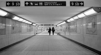 black and white, people in the city underpass