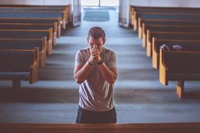 Praying God person in a church