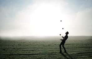 juggler on a field on a sunny day