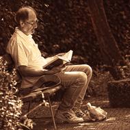 monochrome picture of Man is reading a book in a park